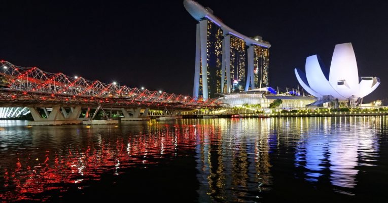 A beautiful shot of the tall architectural buildings of Singapore Marina Bay Sands and Helix Bridge